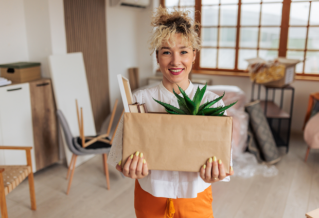 Happy woman unpacking in bright room
