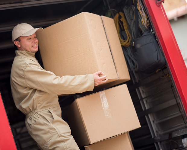 Worker loading boxes into a truck